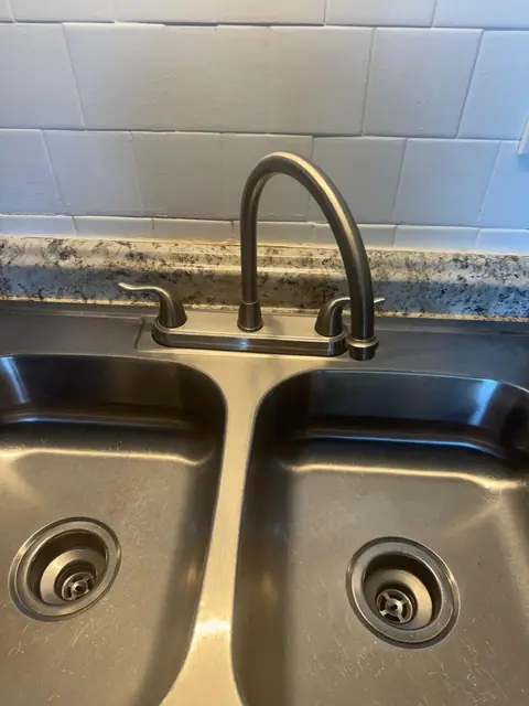 Shiny stainless steel kitchen sink after cleaning