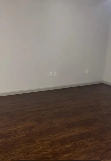 Empty room with clean floors after move-out